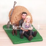 Bride and Groom Sitting with Bale of Hay Wedding Cake Toppers