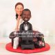 Bride Sitting on Couch While Groom Playing Video Game Cake Toppers