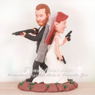 Groom Holding Shotgun and Bride Holding Pistols Wedding Cake Toppers