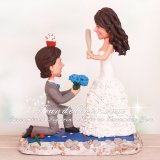 The Bride Hitting a Cupcake Off The Grooms Head Wedding Cake Topper